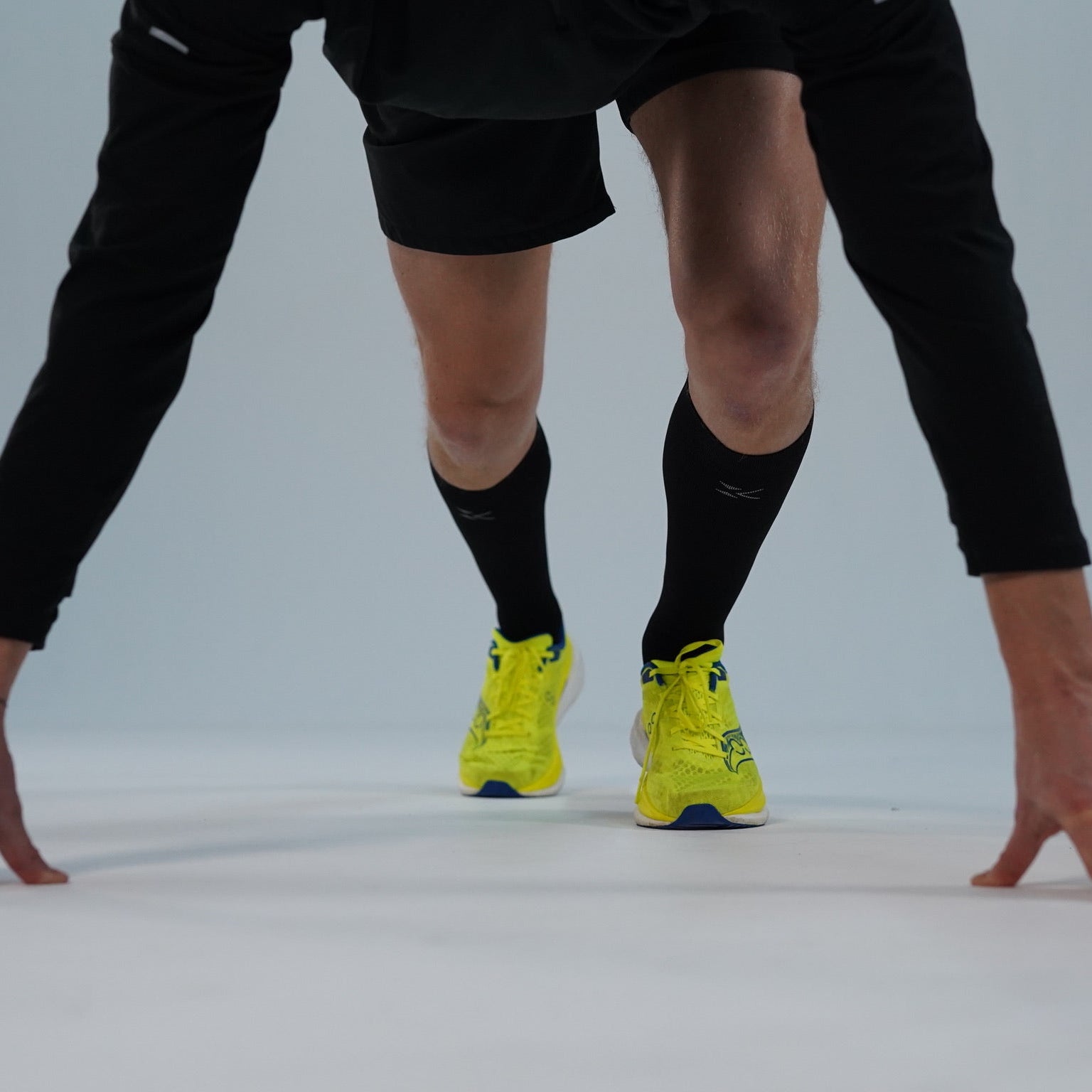 Athlete in running pose wearing compression socks
